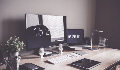 A desk with a computer on a table Description automatically generated