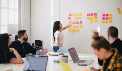 woman placing sticky notes on wall